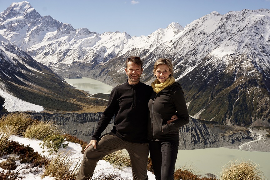 Mann und Frau vor verschneiten Bergen