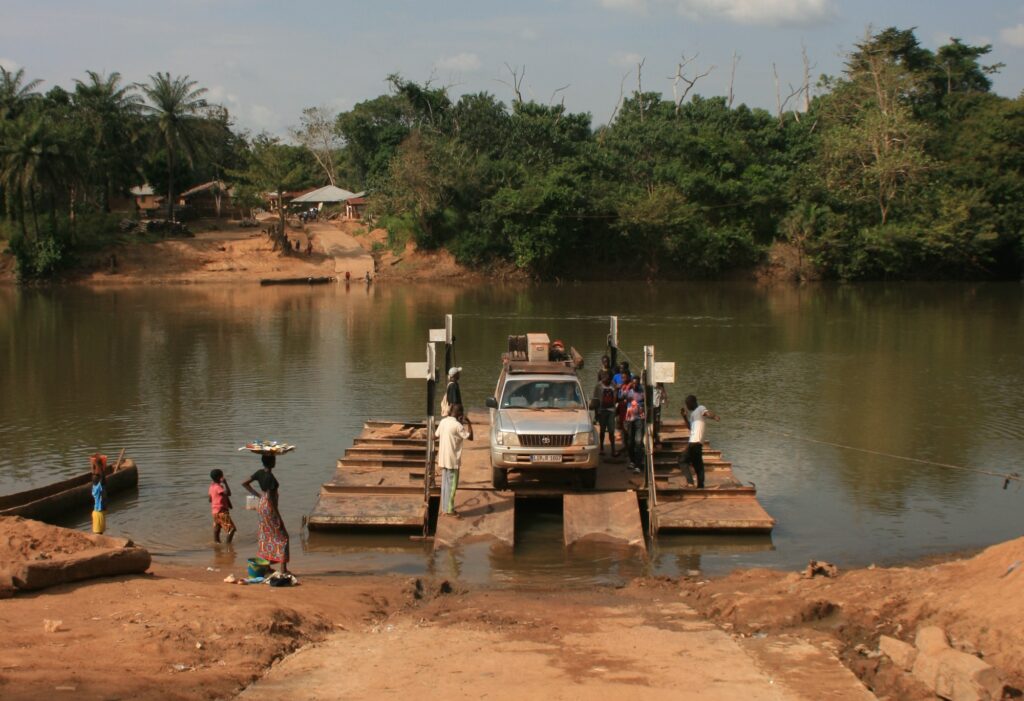 Ein Land Cruiser wird in Afrika auf einem Floß über einen Fluss transportiert
